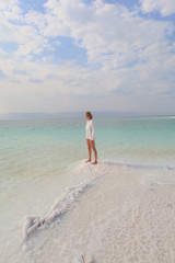 Wall Mural - Woman stands on the Death Sea beach in Jordan