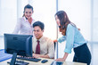 © Pataradon - Group of young teamwork  businesspeople with headset and computer at office.