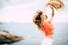 Happiness And Joyful People Concept With Beautiful Caucasian Woman Jump And Have Fun - Summer Holiday Tracvel Vacation And Ocean Defocused Horizon View