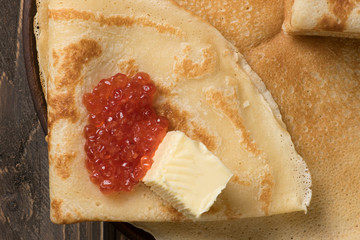 Russian traditional blini - thin pancakes with red caviar. Pancakes are traditional food for Maslennitsa holiday