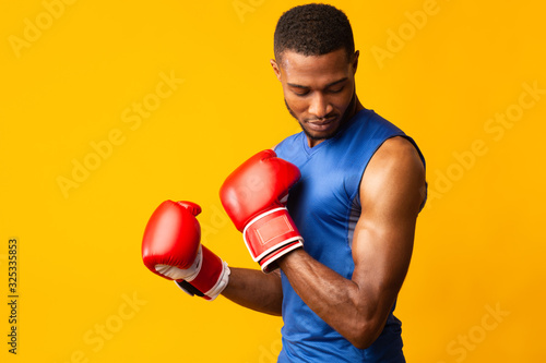 Handsome afro sports man ready for fight at orange studio Fototapete