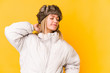 © Asier - Young blonde caucasian woman wearing a winter clothes isolated touching back of head, thinking and making a choice.