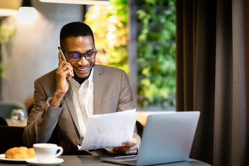 Wall Mural - Portrait of black businessman making phone call