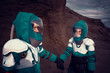 Two Astronauts Wearing Space Suits Holding Hands on Mars/ Red Planet. Love in Space Travel, Exploration and Colonization Concept.