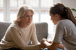 © fizkes - Worrying middle aged woman listening sad daughter.