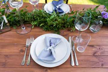 Preparing for an open-air party. Decorated with fresh flowers served tables. Table number. Decoration Details