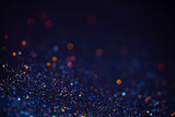 Fototapeta Tęcza - Decoration bokeh glitters background, abstract blurred backdrop with circles,modern design overlay with sparkling glimmers. Blue, golden and black backdrop glittering sparks with glow effect