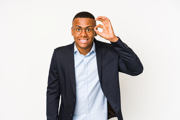 Young business latin man isolated on white background excited keeping ok gesture on eye.