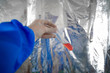 Hands in a protective biological suit holding a test tube. Discovery of a coronavirus vaccine