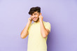 © Asier - Young arabian man isolated on a purple background covering ears with hands.