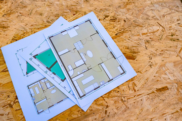 construction plans lie on a chipboard. a variety of layouts of apartments. proposals of construction