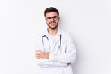 Fototapeta Na drzwi - Young caucasian doctor man isolated laughing and having fun.