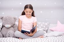 Dreaming Big. Girl Child In Bed Read Book With Teddy Bear Plush Toy. Pleasant Time In Cozy Bedroom. Girl Kid Cute Pajamas Relax And Read Book. Book About Love. Favorite Fairy Tale. Literature Hobby