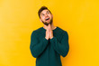 © Asier - Young caucasian man isolated on yellow background making up plan in mind, setting up an idea.