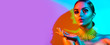 Leinwandbild Motiv High Fashion model woman portrait in colourful bright neon lights, beautiful party girl with trendy make-up, manicure, hairstyle. Pointing hand, advertising gesture over colorful vivid background.