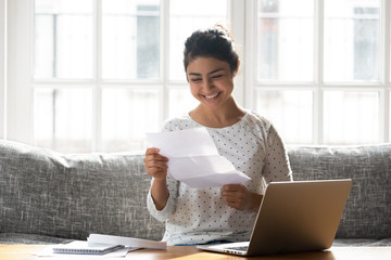 Happy woman holding paper reading good news college admission concept