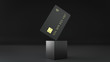 © Ivan - 3d render of the black bank credit card on the cube isolated on a black background with gold detail embossing.