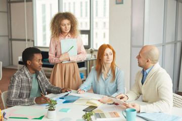 Wall Mural - Portrait of diverse business team collaborating on creative project in modern white office, copy space