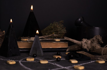 Black magic ritual with candles and runes