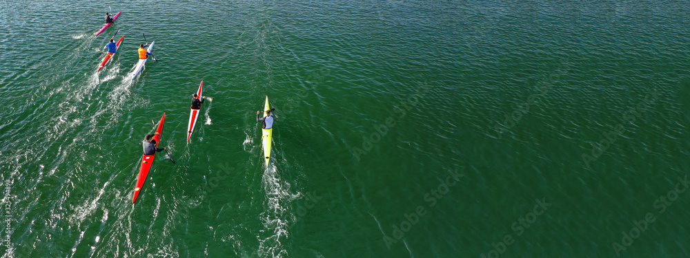 Aerial drone ultra wide photo of young athletes rowing in canoe ...