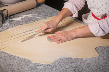 Cutting dough for making tequeños in a venezuelan food exhibition