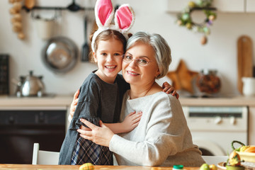 Wall Mural - Happy easter! family grandmother and child with ears hare getting ready for holiday