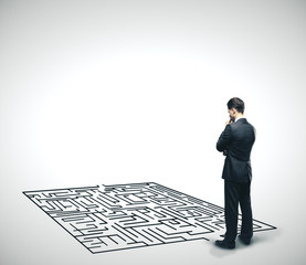 Canvas Print - Businessman looking at labyrinth.