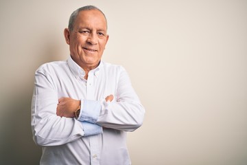 Senior handsome businessman wearing elegant shirt standing over isolated pink background happy face smiling with crossed arms looking at the camera. Positive person.