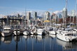 Boat harbour in front of the Burrard Bridge in Vancouver, British Columbia, Canada. It spans False Creek and connects the Kitsilano and West-End neighbourhoods of Vancouver.
