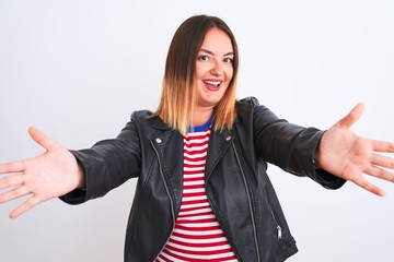 Poster - Young beautiful woman wearing striped shirt and jacket over isolated white background looking at the camera smiling with open arms for hug. Cheerful expression embracing happiness.