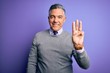 Middle age handsome grey-haired man wearing elegant sweater over purple background showing and pointing up with fingers number three while smiling confident and happy.