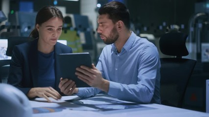 Poster - Industry 4.0 Modern Factory Meeting Room: Chief Engineer Holds Digital Tablet, Shows it to Female Specialist, They Have Discussion. Professionals Design Electronic Machinery With Futuristic Design