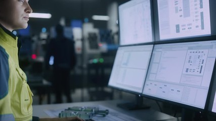 Leinwandbilder - Industry 4.0 Modern Factory: Female Facility Operator Controls Workshop Production Line, Uses Computer with Screens Showing Complex UI of Machine Operation Processes, Controllers, Machinery Blueprints