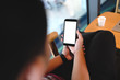 © Thaspol - Close up of man using cell phone,sending massages on the coffee shop with black screen,texting,video calls.