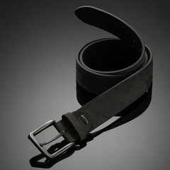 fashionable black leather men's belt on black background