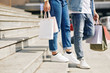 © DragonImages - Cropped image of couple walking down the stairs of mall after shopping together