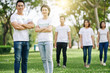 © DragonImages - Happy young Asian volunteers standing with arms folded after cleaning garbage in city park