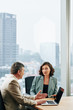 © DragonImages - Serious big company CEO and COO discussing strategy of development at meeting