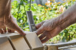 © marketlan - Bricklayer levelling bricks on the new fence from facing bricks using building level.
