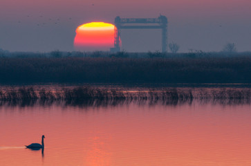 Winter sunrise on the Peene river near the Baltic Sea. In the picture remains of the lift bridge near Karnin.