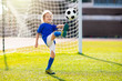 © famveldman - Kids play football. Child at soccer field.