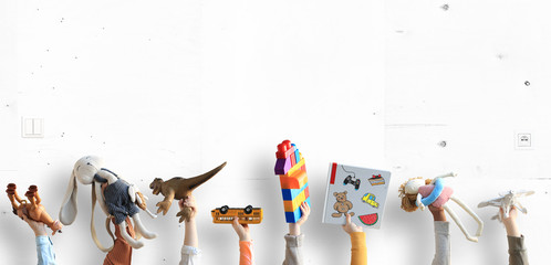 Wall Mural - Children hands holding toys, concept of the childhood