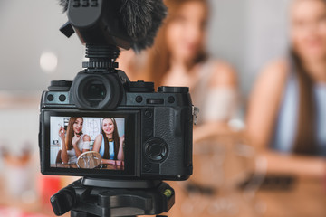 Wall Mural - Young beauty bloggers recording video at home