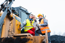 Woman And Man Worker In Quarry On Excavation Machine