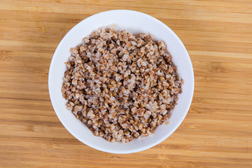 Top view of buckwheat porridge in the white bowl