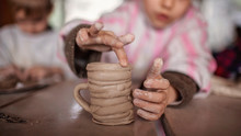 Cute Little Kids Playing Together With Modeling Clay In Pottery Workshop, Craft And Clay Art