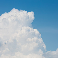 fluffy white cloud above clear blue sky background