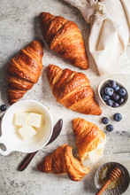 Fresh Croissants With Blueberries, Butter And Honey, Gray Background, Top View.