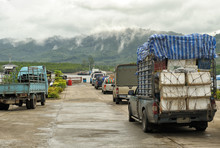 Cars And Pick-ups, Transporting Food For Hotels, In Queue Waiting In Line For Ferry In Thailand.