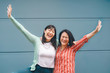 © Alessandro Biascioli - Happy Asian family having fun  outdoor - Chinese mother and daughter enjoying time together outside - Parents lifestyle relationship and youth and older people concept - Blue background